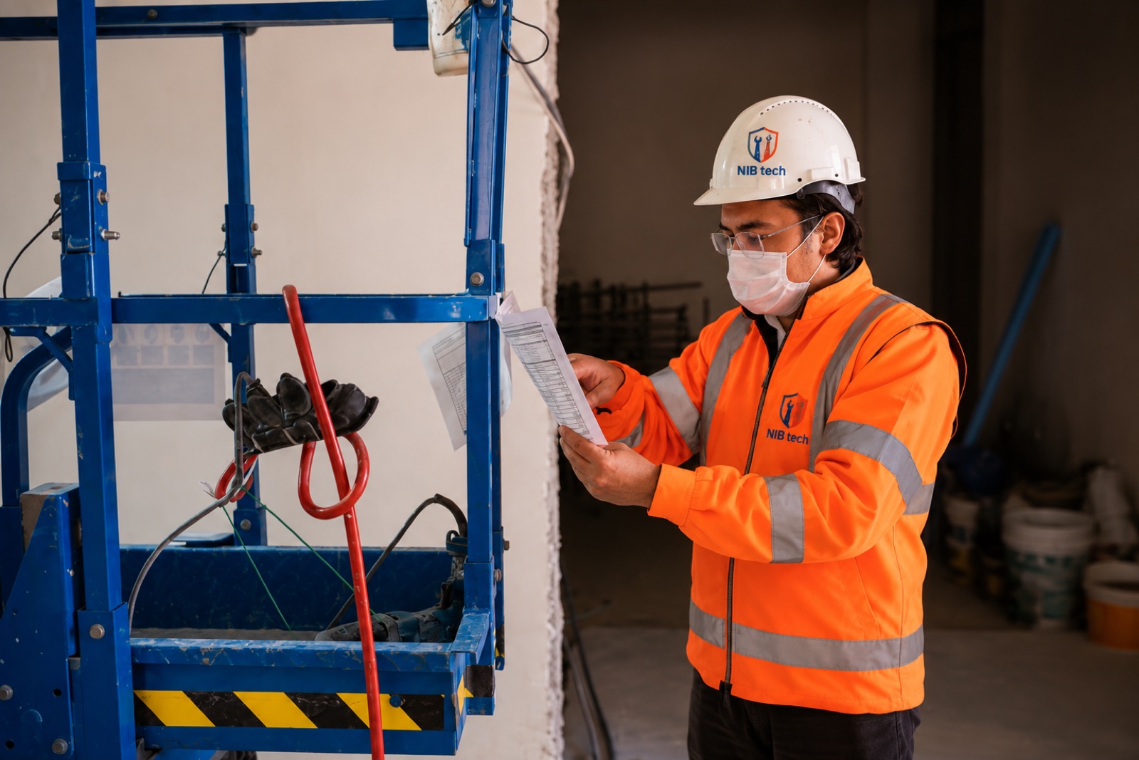 NIBTECH inspector reviewing an inspection checklist beside a mobile access tower